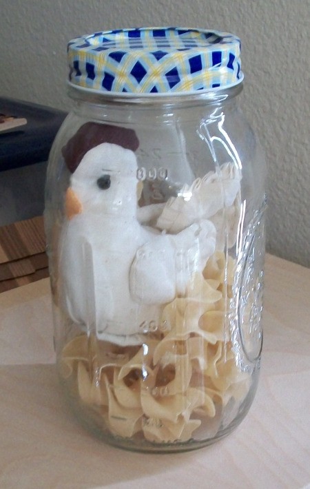 "Chicken" and egg noodle pasta inside of a quart mason jar