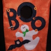 Orange treat bag with a ghost and bat motif.
