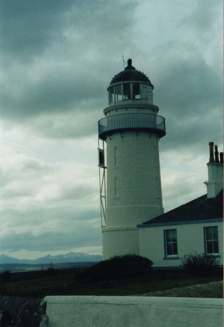 Lighthouse on Isle of Bute in Scotland With Grey Cloud in Background