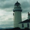 Lighthouse on Isle of Bute in Scotland With Grey Cloud in Background