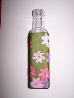 third side of bath salt bottle with flowers applied to green paper wrapped around it