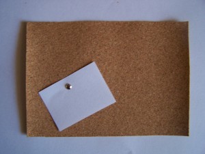 Cork Board wth Paper Note attached with a brad.