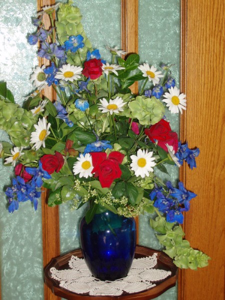 Bouquet of Red, White and Blue Flowers in a Blue Vase