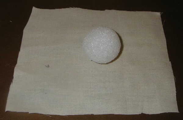 Styrofoam ball on a square of fabric
