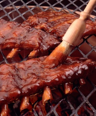 A rack of baby back ribs on the grill.