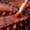 A rack of baby back ribs on the grill.