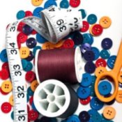 Spools of thread, buttons, scissors, and a tape measure.