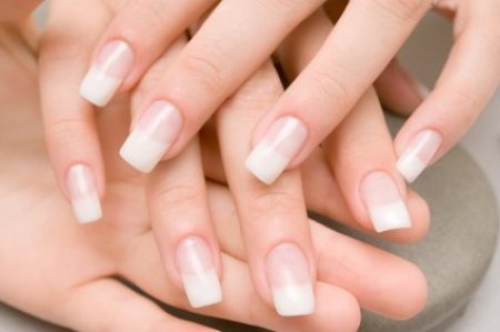 Photo of a woman's hands with acrylic nails on.