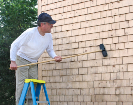 Man Cleaning Wood Siding