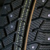 Saving Money on Studded Tires, A close up of the studs on the tread of a snow tire.