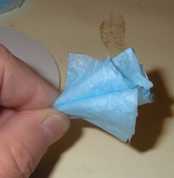 Pinched piece of blue tissue paper