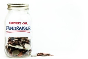 Money jar with label that says "Support Our Fundraiser" on white background