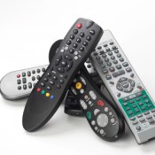 A stack of remote controls for various electronics.
