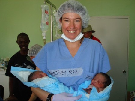 Twin Newborns Held by Doctor in Haiti