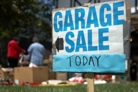 Garage Sale Sign in Front of House Having a Sale