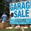 Garage Sale Sign in Front of House Having a Sale