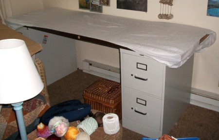 An old door on a file cabinet to use as a desk.