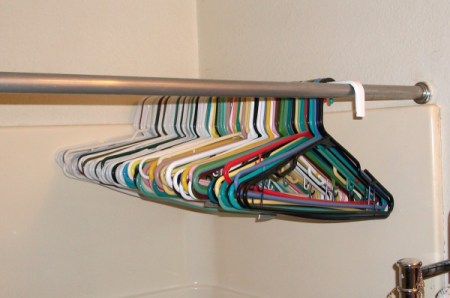 Hang extra hangers on a closet rod in the shower.