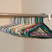Hang extra hangers on a closet rod in the shower.