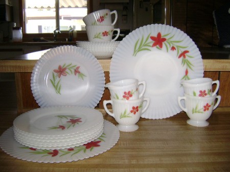 Tableware set: white with red flowers and leaf spray around half of outside edge. The edges appear to be ruffled.