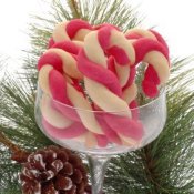 Glass stemmed dish filled with red and white candy cane cookies.