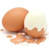 Two brown eggs, one peeled part way, on white background.
