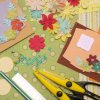 Scrapbooking papers, embellishments, and scissors.