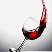 Removing Red Wine Stains from Marble, Removing Red Wine Stains from Clothing, Glass of red wine tipping over with wine splashing out.