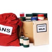 Collection of dried and canned foods including box of powdered milk.