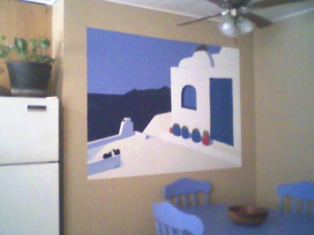 A white and blue mural painted on a kitchen wall.