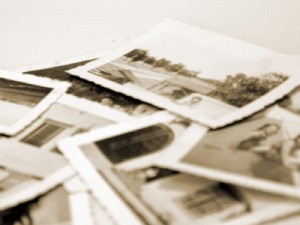 A stack of old black and white family photos.