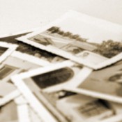 A stack of old black and white family photos.
