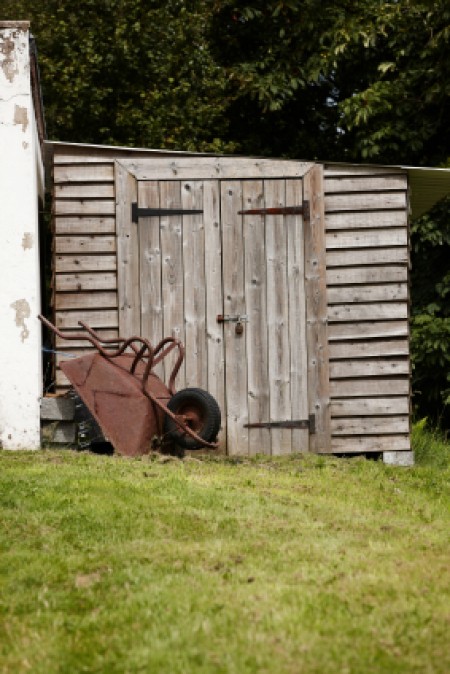 A garden shed built slightly on a hill.