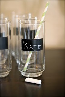 Tall Glasses with black stripe of chalkboard painted on them. The glass centered inthe image has Kate written on it, a yellow striped straw in the glass and a piece of chalk laying in front.