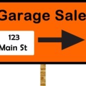 Orange garage sale sign with large black arrow and address in lower left corner.