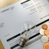 Saving Money on Your Electric Bill, Money and Light Bulb on Top of Electric Bill