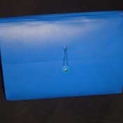 A blue expandable file box for important paperwork.