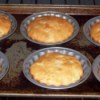 Tray of baked muffin tops in oven