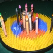 A plastic dartboard used for storing crayons.