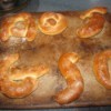 A batch of soft pretzels in letter shapes.