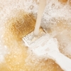 Cleaning Paint Brushes, A paint brush being rinsed off in a sink.