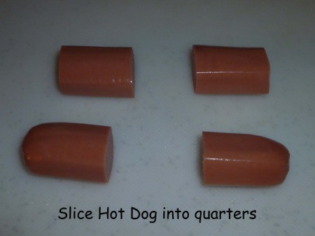 Hot dog cut into four pieces.