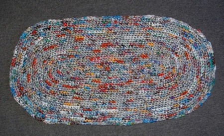 Multicolored crocheted oval rug.