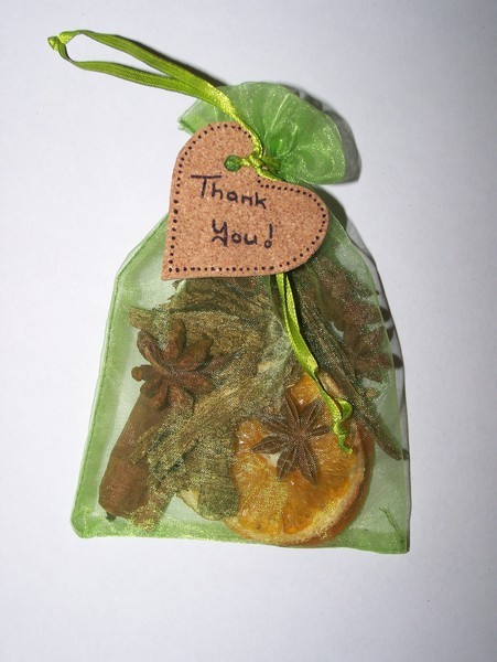 Green mesh potpourri bag filled with potourri, heart cork attached