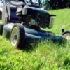 Lawnmower mowing long grass.