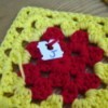 Granny square with bread closure attached, marked with a J.