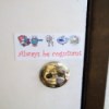 Small sign with icons over the door lock.