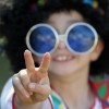 Boy Holding up Peace Sign in Hippie Costume