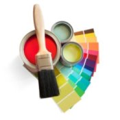 Cans of house paint, paint chips, and a paint brush.