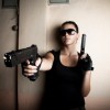 Woman Dressed as Lara Croft Pointing Gun